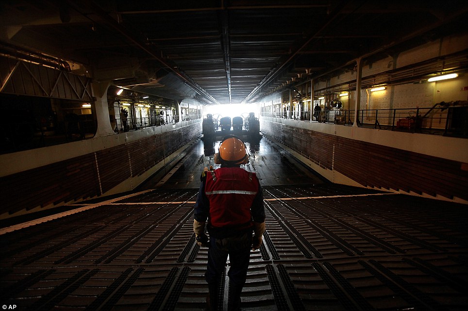 Time to move? A French Navy sailor watches as a U.S. hovercraft docks in the hold